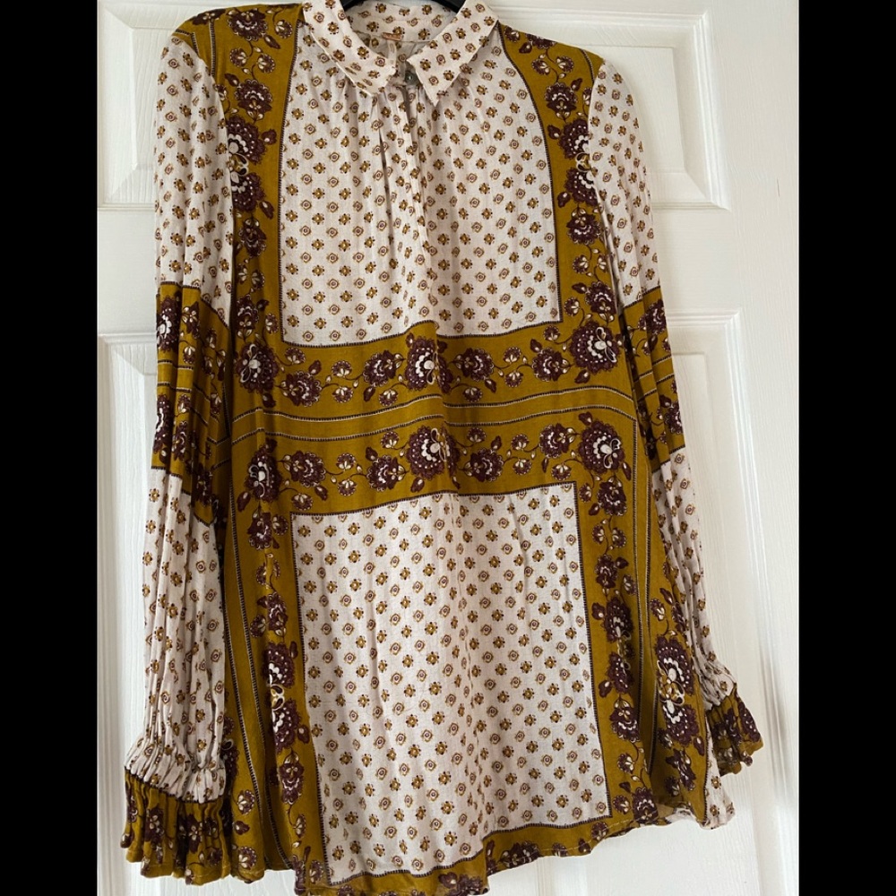 Free people tunic with complementary patterns of browns and gold.